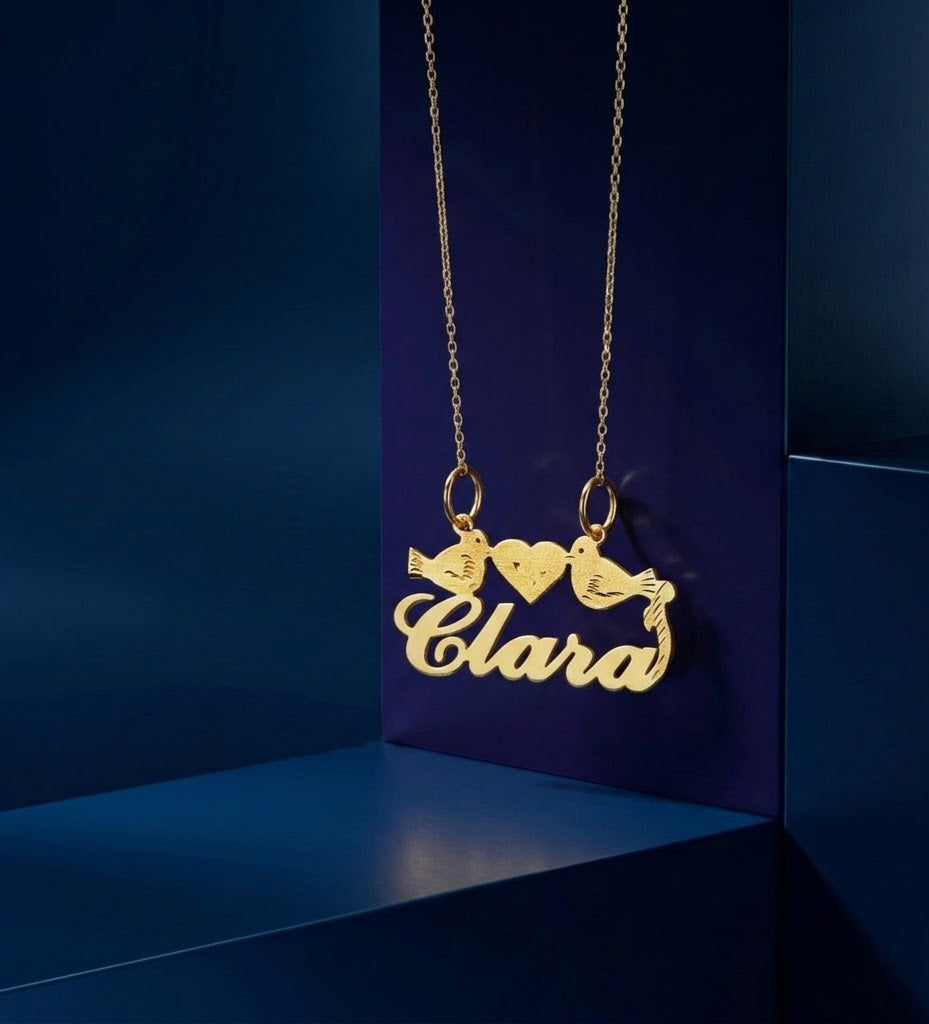 High-end handcrafted name necklace with artistic lovebirds detailing, made in Los Angeles in radiant yellow gold with refined script-style personalization
