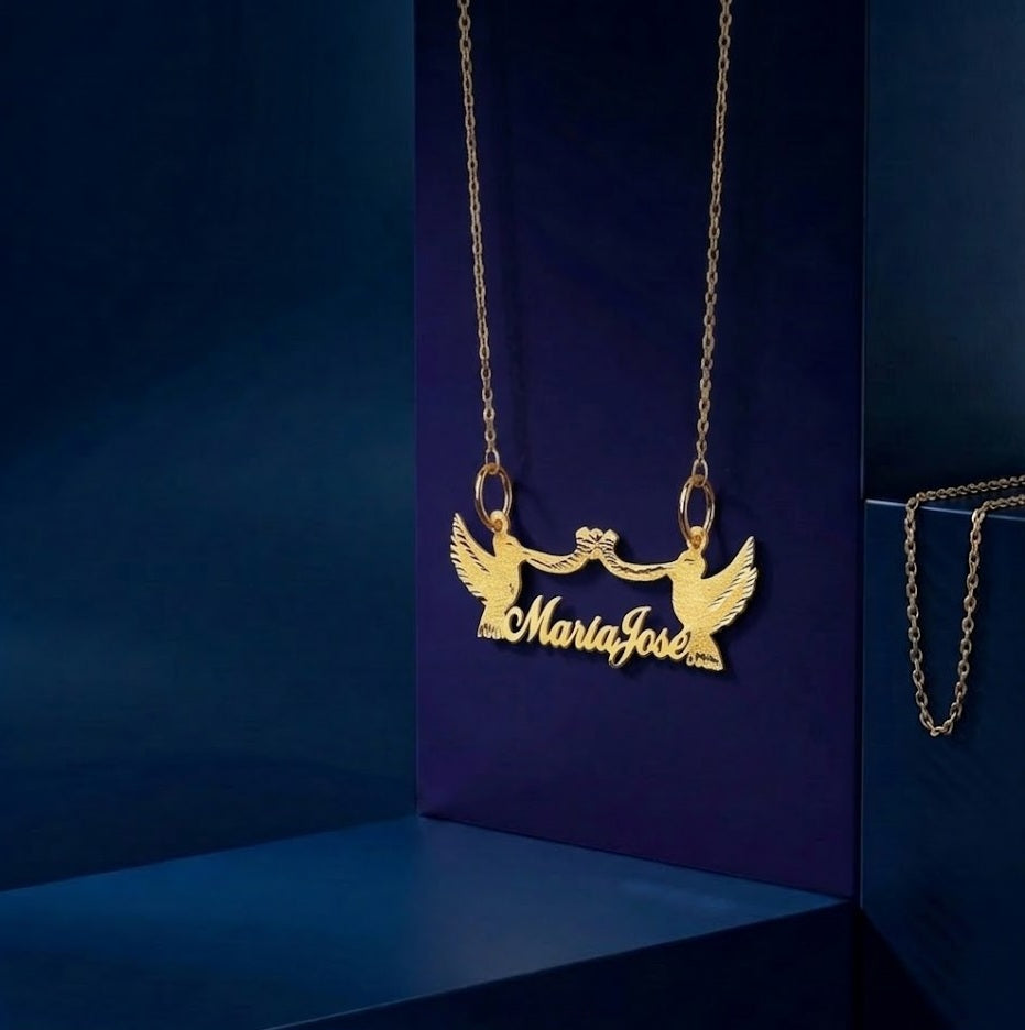 Handcrafted gold pendant with custom script lettering, double dove motifs, and soft satin finish, designed as a signature luxury personalized gift by CustomGolds INC