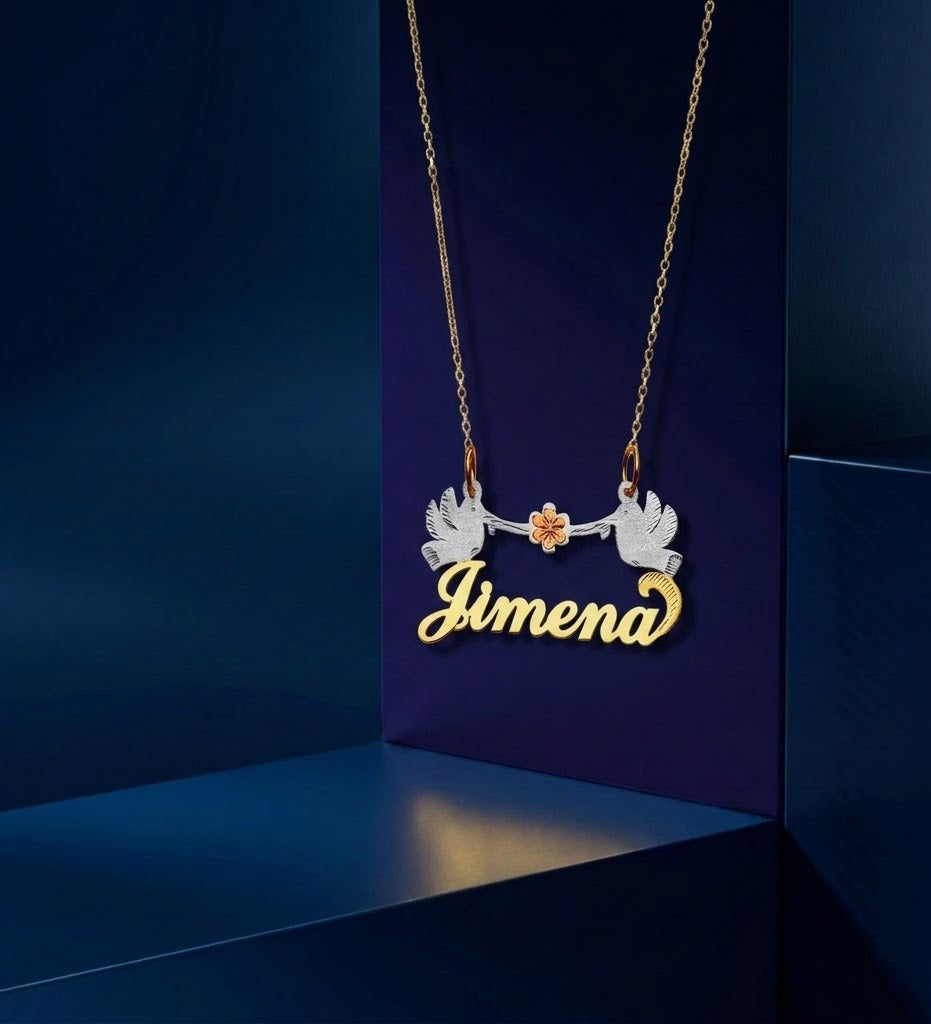 Handcrafted bespoke gold name necklace with delicate birds and floral accents, designed in a tri-color blend of 14K and 18K gold for a refined custom jewelry look.