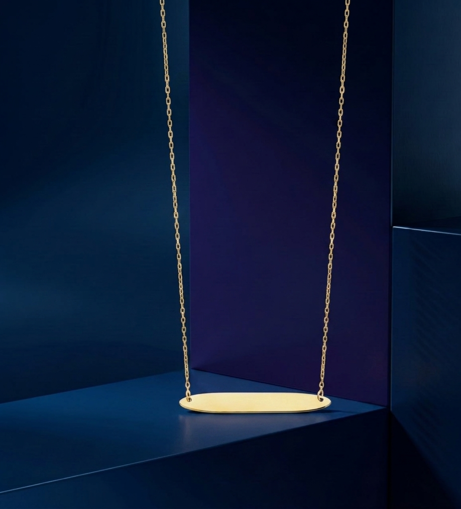 High-end handcrafted oval bar pendant necklace in 18K gold with custom engraving, polished fine jewelry designed as a personalized luxury gift by master jewelers at CustomGolds INC.