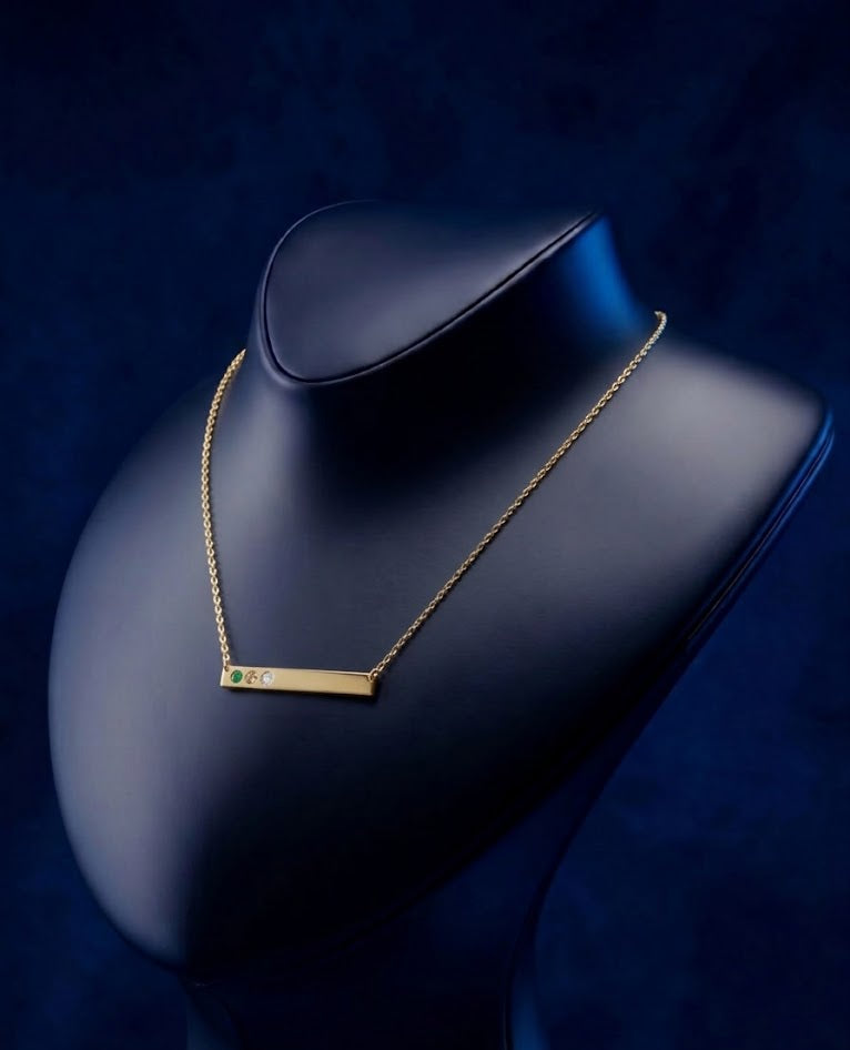 Elegant personalized nameplate pendant in 18k solid gold with three gemstone accents, designed as a modern fine jewelry piece with satin-soft polish and luxury craftsmanship by CustomGolds INC