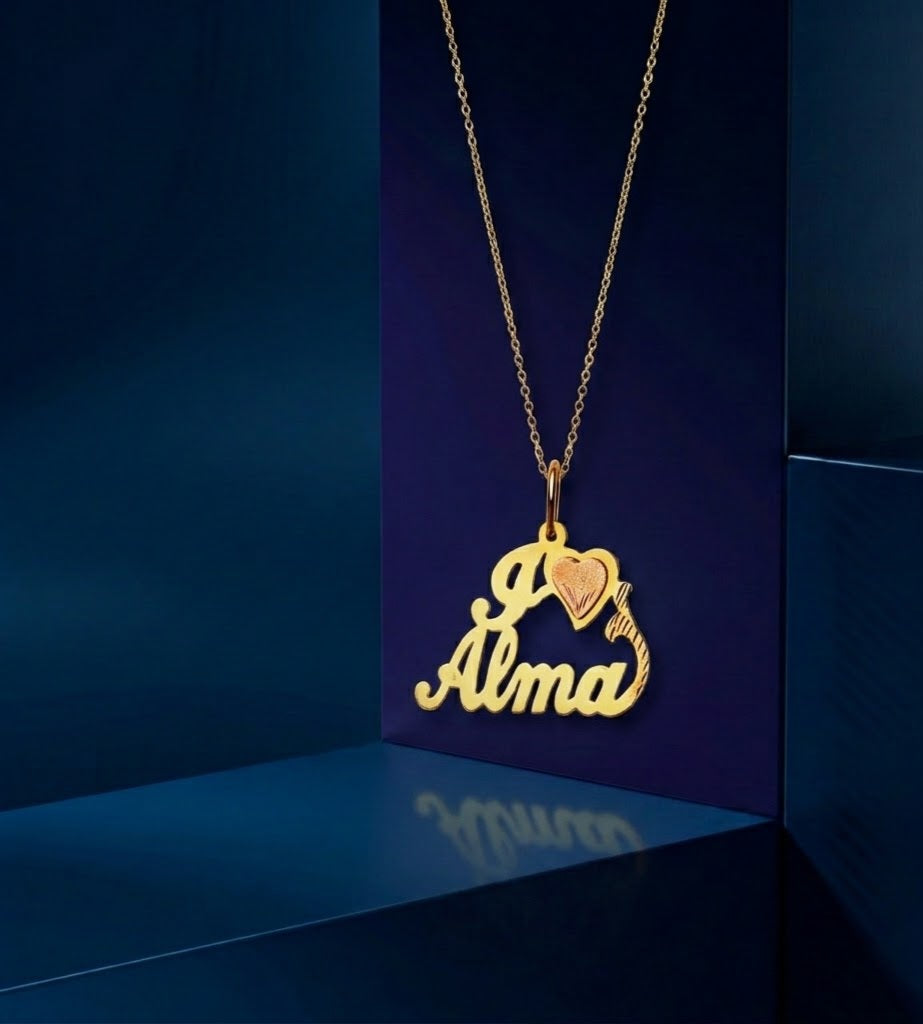 Bespoke two-tone gold name necklace with faceted heart charm, personalized engraving, and signature handcrafted finish, designed for modern luxury and everyday elegance.
