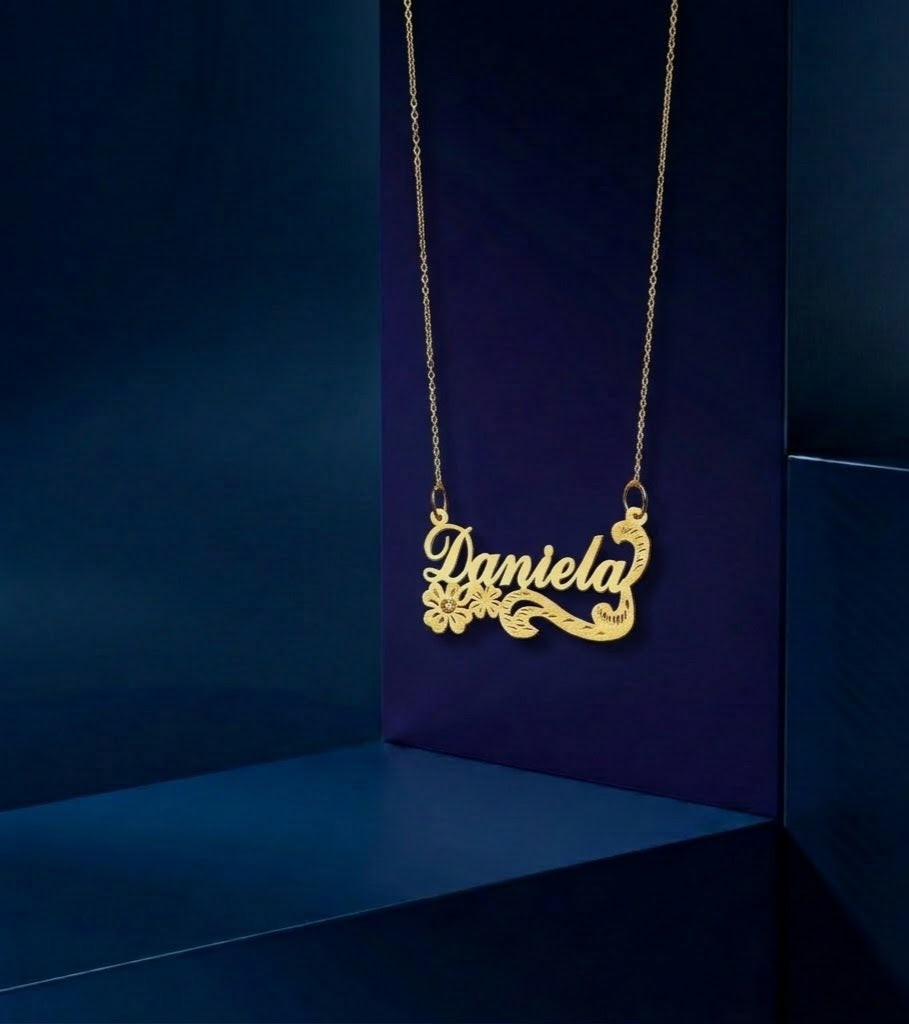 Handcrafted nameplate necklace with script typography and floral motif, available in 14k gold and rose gold plating with premium polished surface.