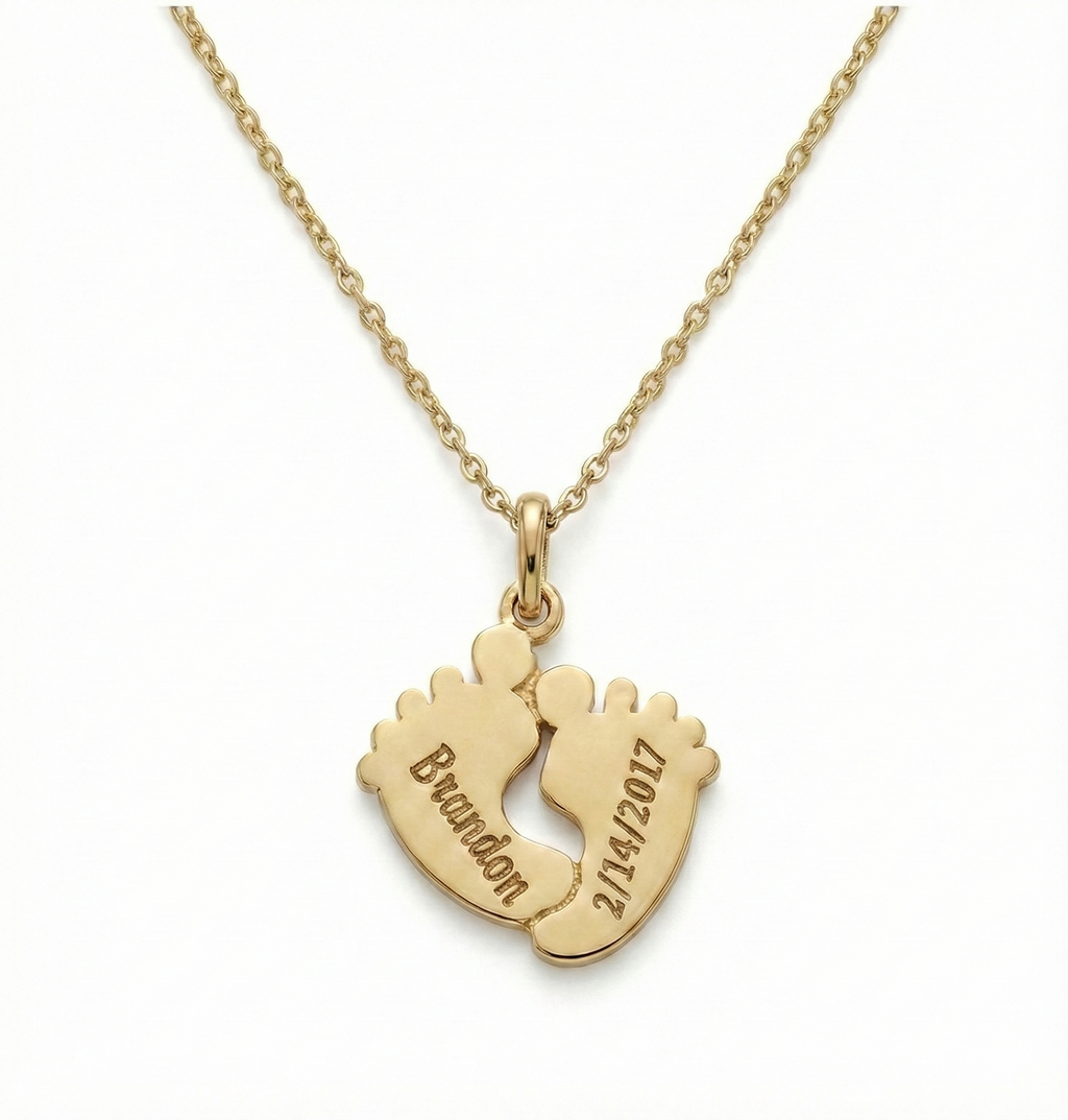 Close-up of engraved Footprints Necklace showing fine detailing in gold vermeil sterling silver