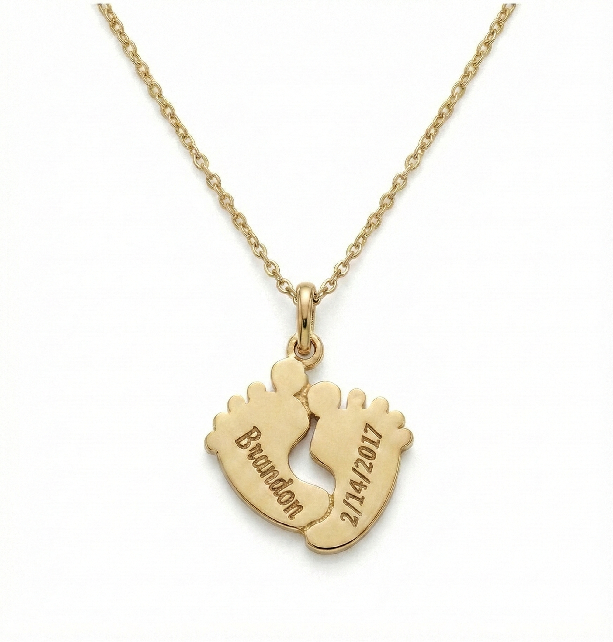 Close-up of engraved Footprints Necklace showing fine detailing in gold vermeil sterling silver