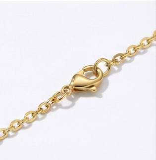 Close-up of engraved baby footprints necklace showing gold vermeil sterling silver detail