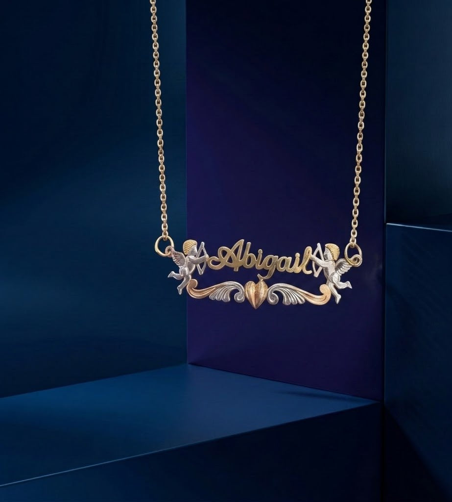 Custom gold lettering necklace with romantic Cupid and heart design, signature personalized jewelry piece by CustomGolds INC, crafted as a premium bespoke nameplate pendant with fine detailing and elegant shine.