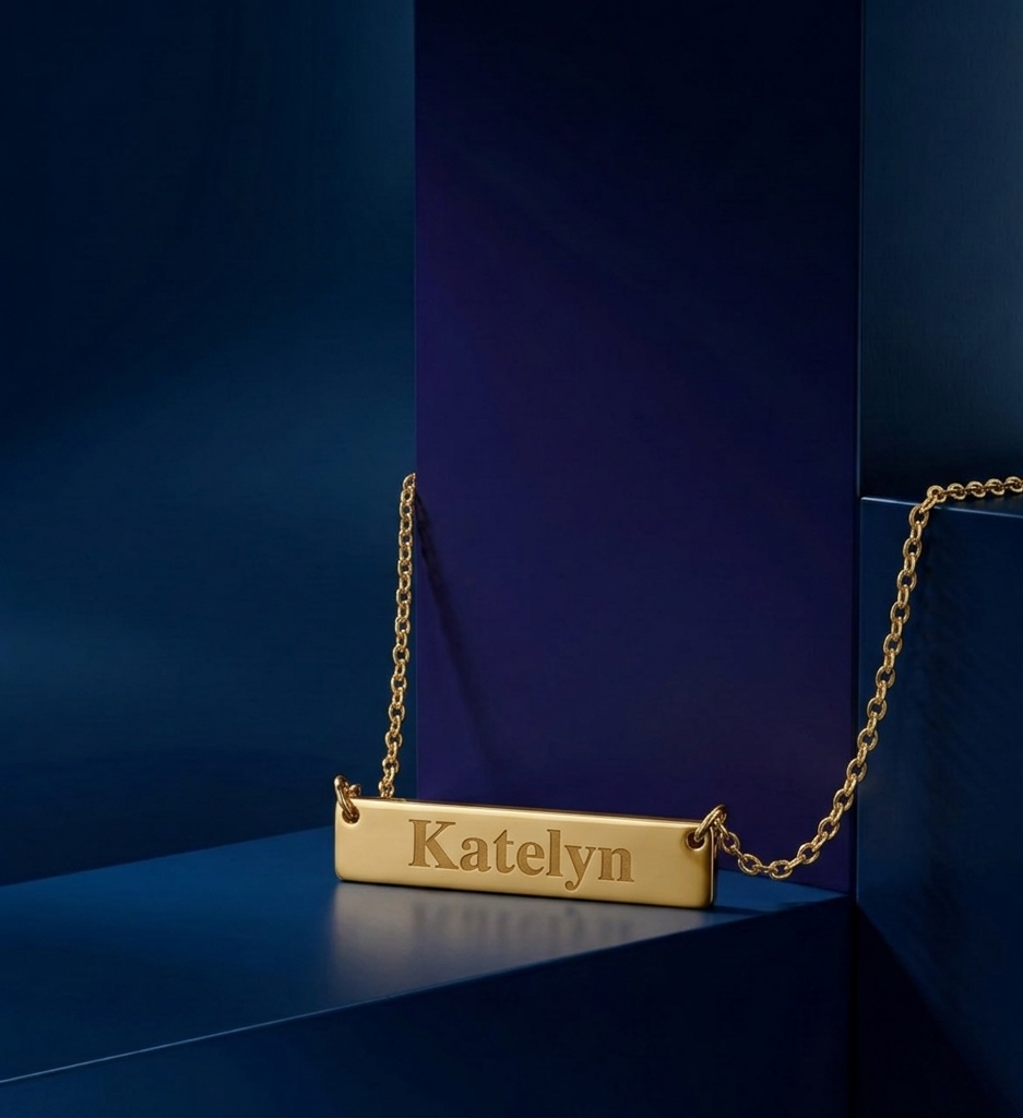 Custom yellow gold bar necklace with engraved name detail, designed in an elegant modern style with soft matte-polish contrast by CustomGolds INC