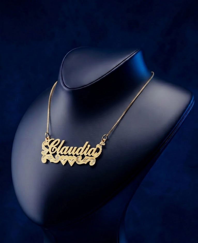 Elegant 18k solid gold custom name necklace with script lettering, double hearts design, and high-polish diamond-cut texture for a premium personalized jewelry piece.