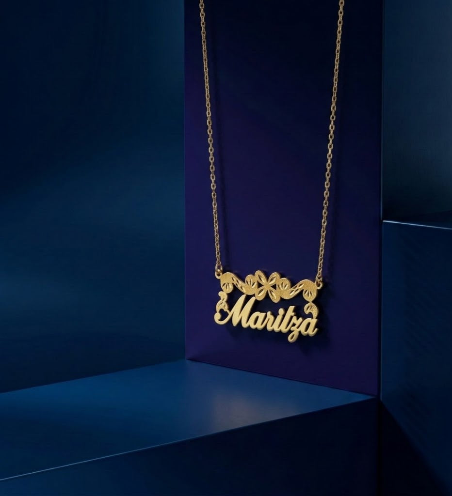 Luxury custom 14k gold name necklace with decorative floral engraving and diamond-textured accents, premium personalized jewelry piece made by CustomGolds INC.