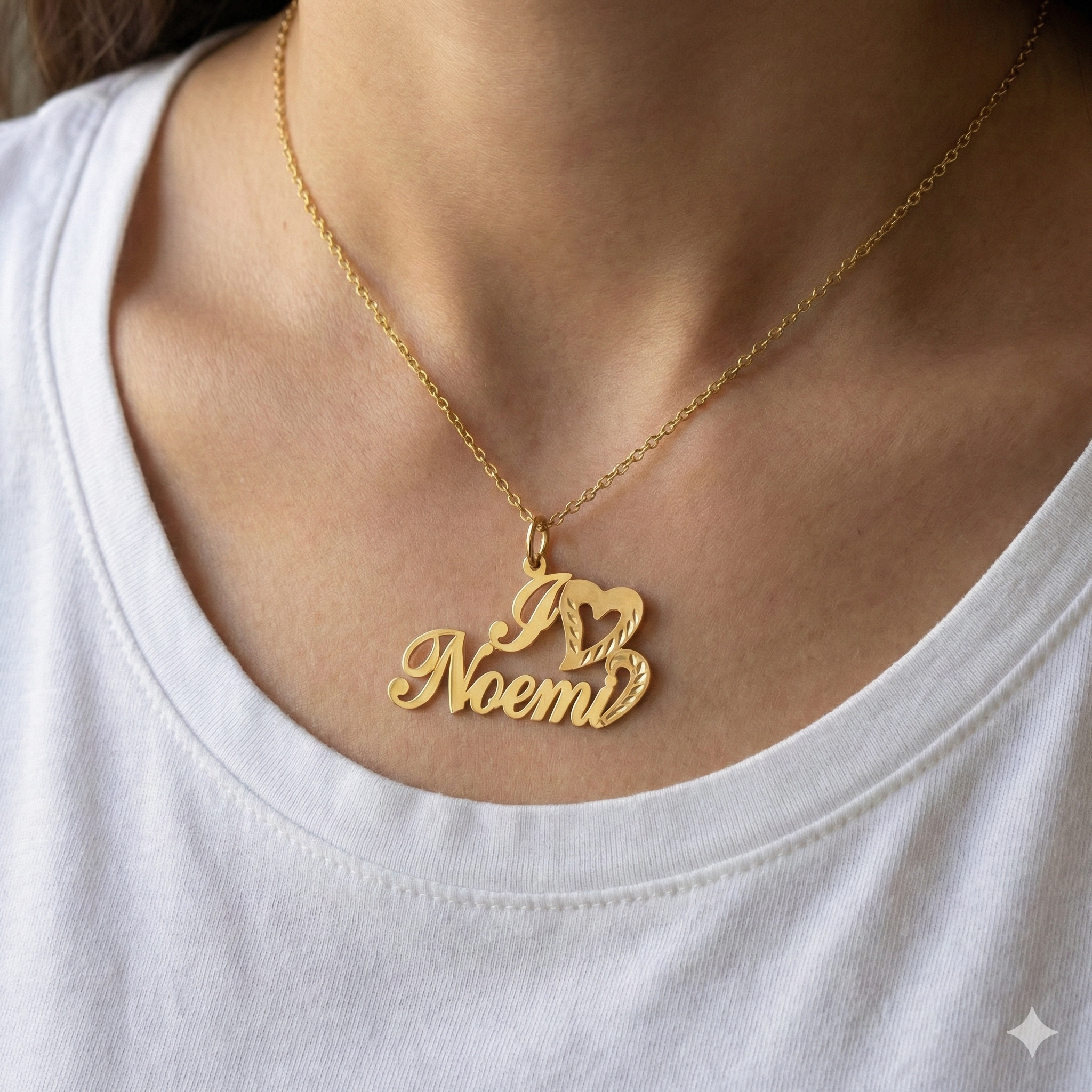 Gold necklace with 'I love Noemi' pendant on a white shirt