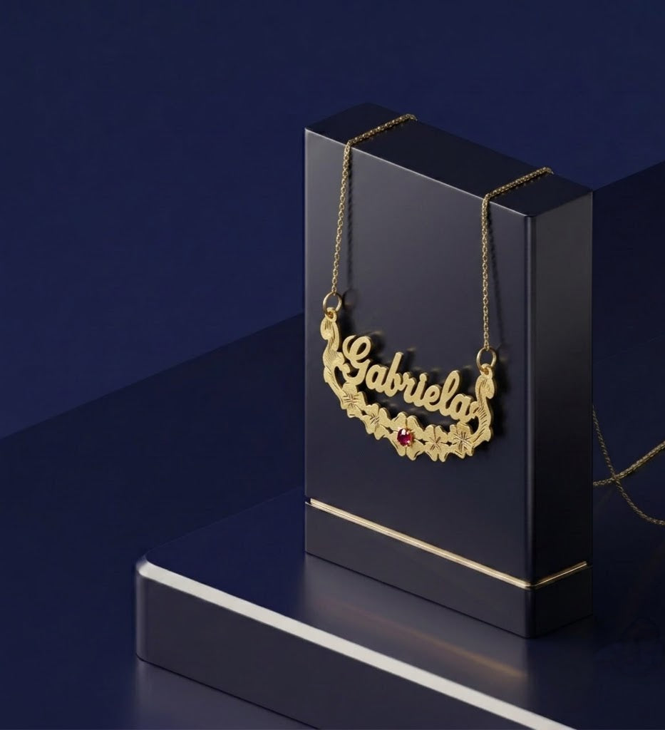 Personalized floral name necklace with custom gold lettering and gemstone accent, handcrafted with a script font, satin-soft finish, and premium 14k gold craftsmanship for an elevated artisanal look.