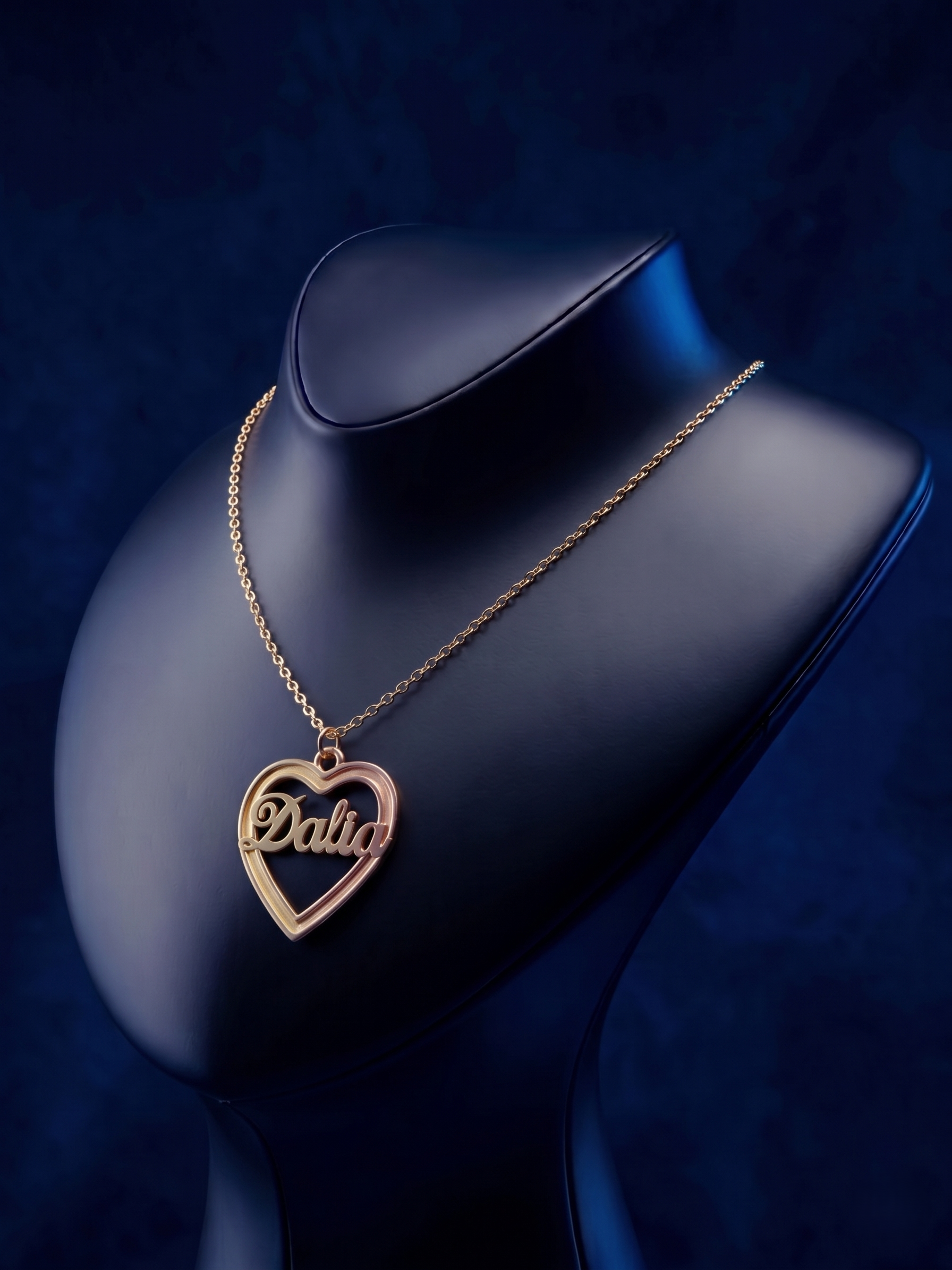Bespoke multi-tone gold necklace with a heart outline and dimensional name design, offering a luxury handcrafted finish and a modern personalized script style