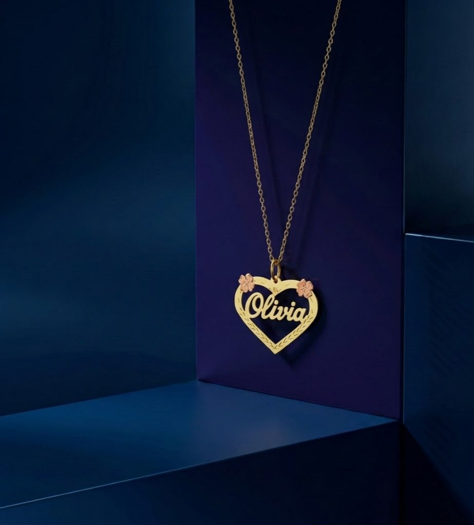 Elegant personalized gold name necklace featuring a floral heart outline, custom lettering, and handcrafted detailing for a luxury fine jewelry gift.