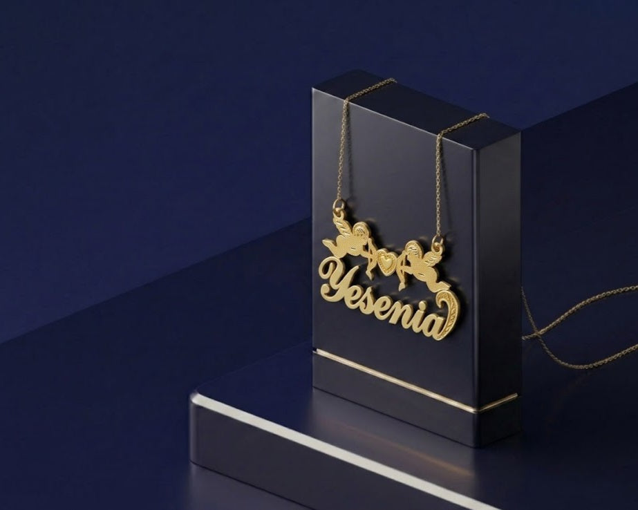 Elegant custom name necklace with double cupid cherubs and heart centerpiece, handcrafted in sterling silver or yellow gold with a soft satin high-end finish.