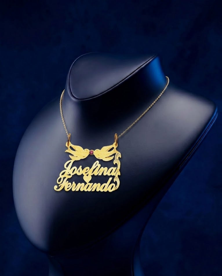 Elegant dual-name gold pendant with Lovebirds motif and ruby detailing, finely handcrafted jewelry designed for a romantic and sophisticated style