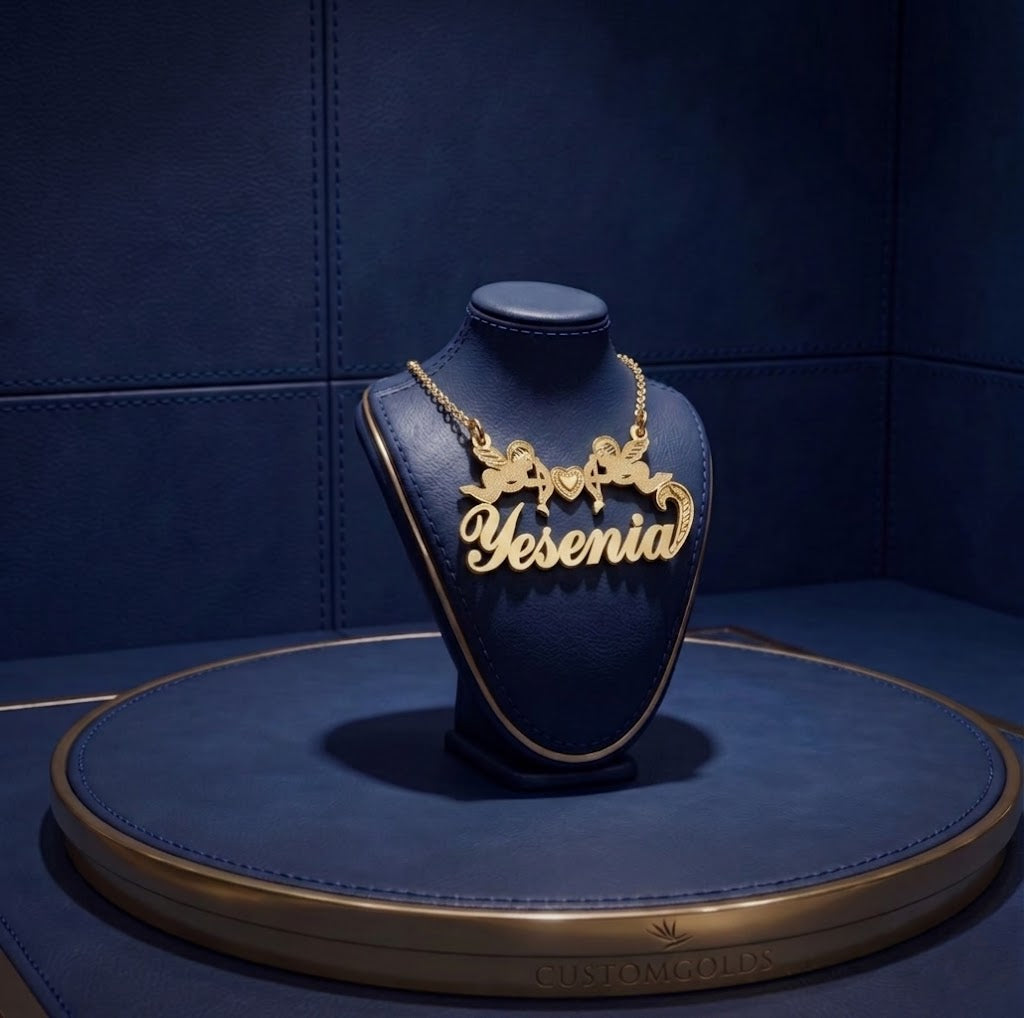 Premium handcrafted gold name necklace with double cherub heart motif, personalized lettering, and luxury custom design by master jewelers at CustomGolds INC.