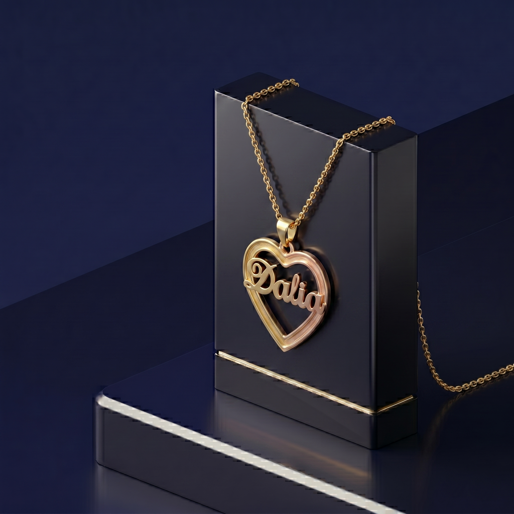 Custom-made 3D name pendant framed in a delicate heart form, designed in mixed gold hues with a polished artisan finish for a sophisticated personalized accessory