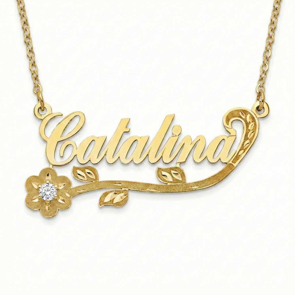 Gold necklace with 'Catalina' and floral design on a white background